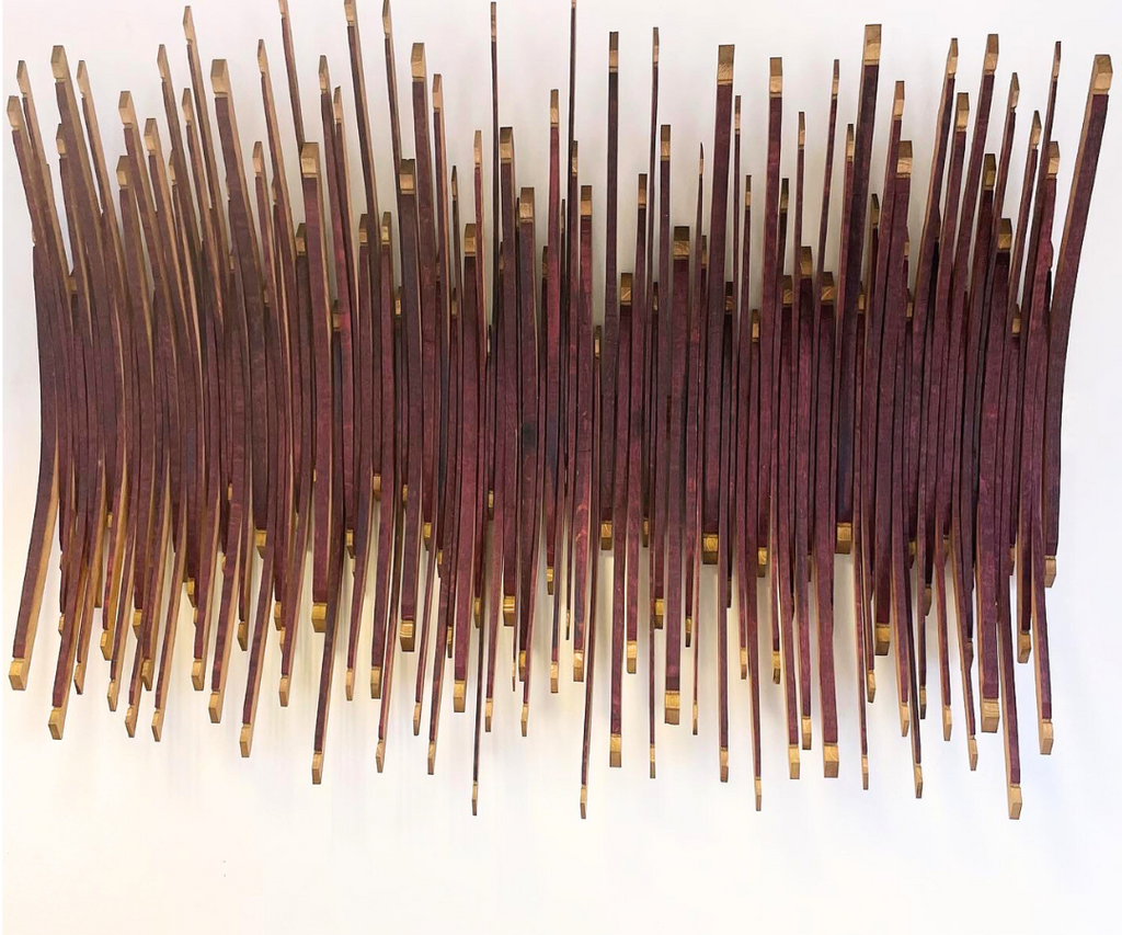 a front on view of the burgundy wine barrel art piece